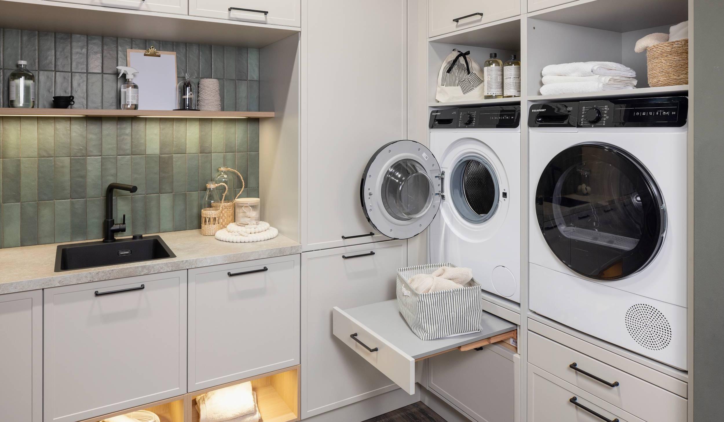 HÄCKER Systemat Hauswirtschaftsraum Lichtgrau Kalkstein - Detailansicht ergonomisch verbaute Waschmaschine und Trockner